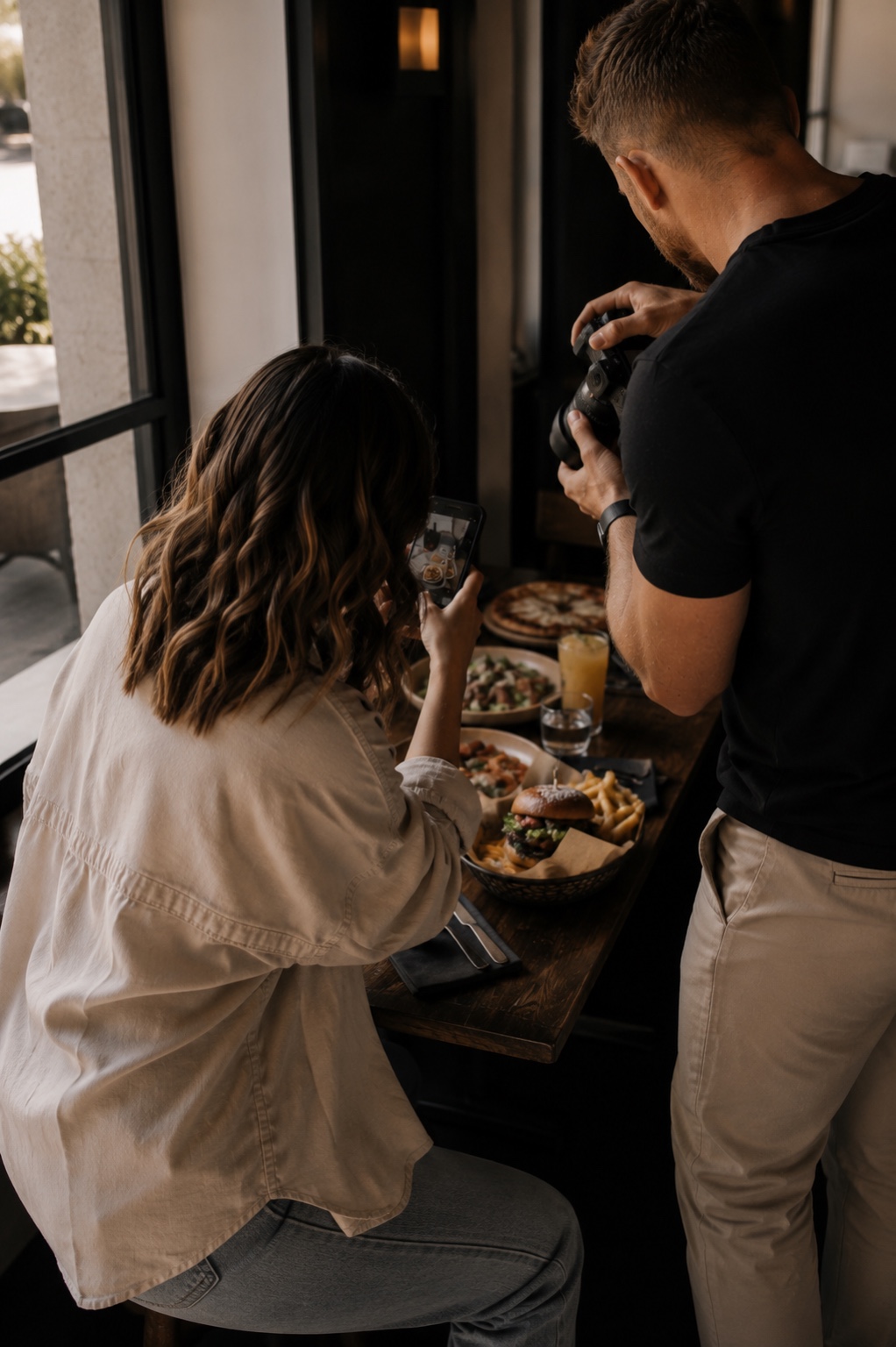 Click & Curate founders photographing restaurant food during a content shoot